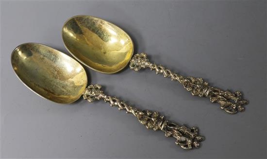 A pair 19th century continental silver gilt spoons with figural terminals, 17.6cm.